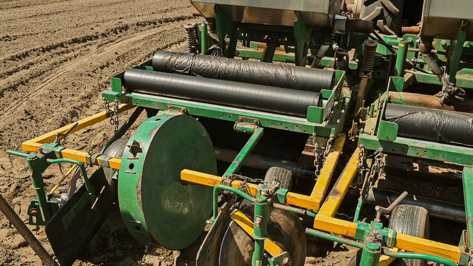 Rolls of black biodegradable mulch film mounted on a mulch-laying implement